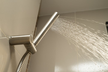 Shower Head and Shower Hose stainless steel push smooth water flow near window sunlight