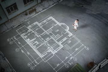 Woman engineer thinking over his plan. Mixed media