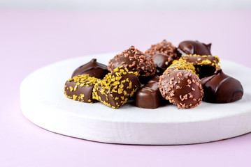 Different Type of Chocolate Candies on Pink Background Tasty Chocolate Candies Dessert Above Horizontal