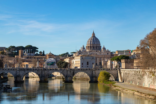 Rome skyline with Vatican St Peter Basilica and St Angelo Bridge crossing Tiber River in the city center of Rome Italy. It is historic landmark of the Ancient Rome and travel destination.