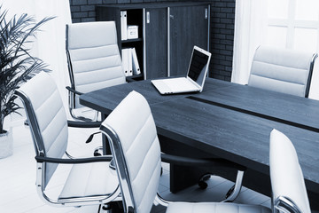 laptop on a desk in modern office