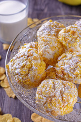 Tasty and beautiful cornflakes cookies and a glass of milk on a wooden table, vertical orientation