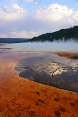 Sunset fumes over the Grand Prismatic pool in Yellowstone National Park, United States