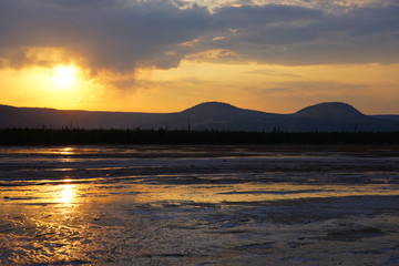 Sunset fumes over the Grand Prismatic pool in Yellowstone National Park, United States