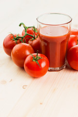 Glass of tomato juice with tomatoes