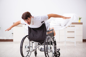 Young handsome man in wheelchair at the hospital 