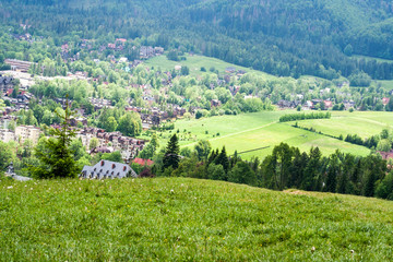 The landscape seen from Gubałówka in Poland in the summer season. Beautiful green natural vegetation and houses inhabited by people.