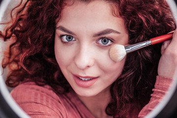 Face of a positive nice woman with curly hair