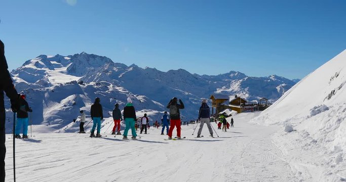 group of people on sunny slope at 3 valleys ski resort in Alps, France