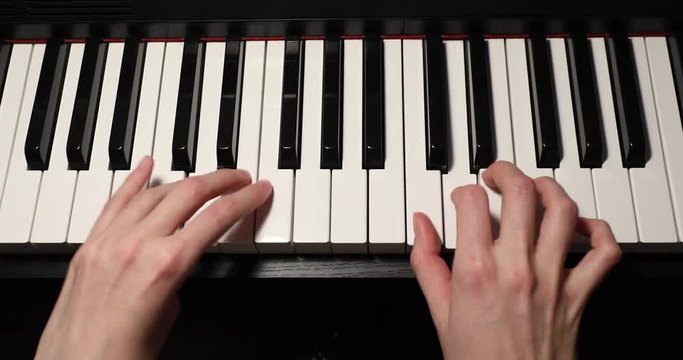 female hands musician doing musical exercise on an electronic piano