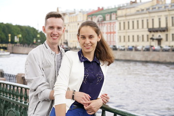 charming good couple husband and wife walking around the city, hugging and spending time with love