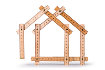 Wooden folding meter ruler in the shape of two houses. Isolated on white background. Clipping path included.