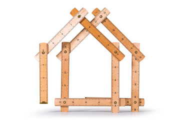 Wooden folding inch ruler in the shape of two houses. Isolated on white background. Clipping path included.