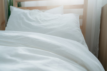 Bed maid-up with clean white pillows and bed sheets in beauty bedroom. Close-up. interior background