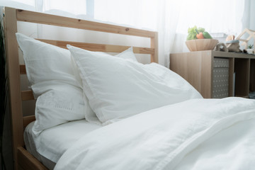 Bed maid-up with clean white pillows and bed sheets in beauty bedroom. Close-up. interior background
