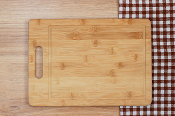Blackboard and tablecloth, napkin on a wooden table. Top view mockup.
