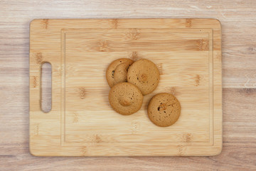Homemade round cookies on a wooden board on a table, closeup