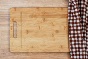 Blackboard and tablecloth, napkin on a wooden table. Top view mockup.