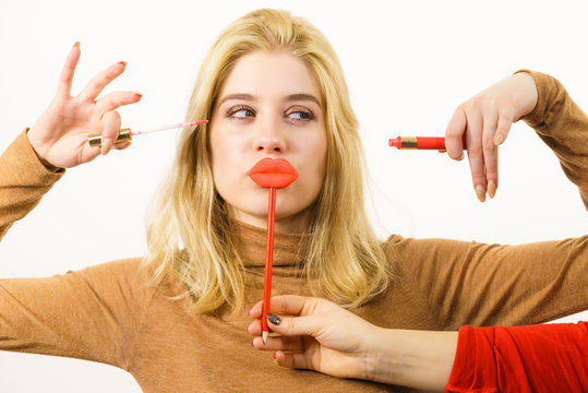 Woman applying lipstick or lip gloss