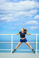 Fototapeta premium Girl wearing roller skates on seaside