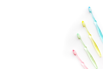 Clean teeth. Colorful plastic toothbrushes on white background top view space for text