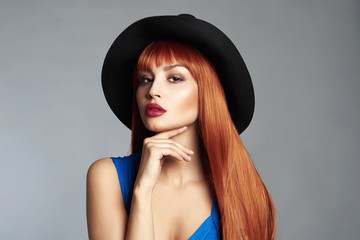 Beautiful red hair woman in hat