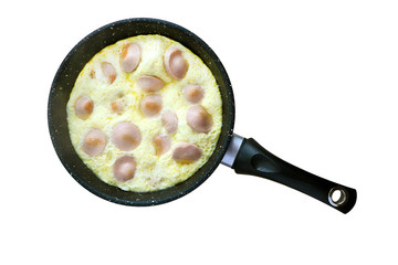 pan with scrambled eggs and sausages on a  white background