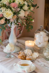 table decorated with fresh flowers and served for tea drinking