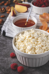 cottage cheese with fresh berries, honey, apples,  tangerines, and nuts, healthy breakfast, diet vegetarian food