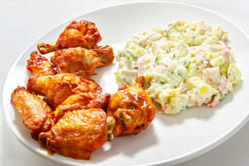 Crispy chicken wings and potato salad