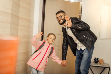 Obraz premium Pretty long-haired girl and a tall bearded man looking happy