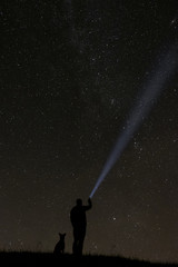 man looking at the stars with his dog