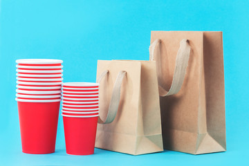 Red paper cups rows on blue background with copy space, beyond plastic free concept