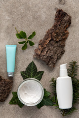 Obraz na płótnie Canvas Skin care cosmetics flat lay styled with leaves