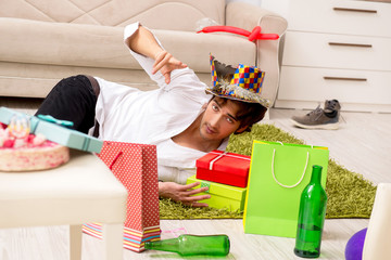 Young man having hangover after party 