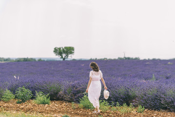 beautiful slim woman is relaxing in lavender field