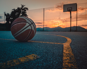 basketball with sunset in the background