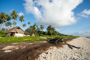 Old boat at the diani beach in Kenya. Beautiful view on beach and palm tree.