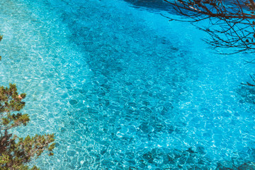 Blue water background. Turquoise ripple water with sun reflections