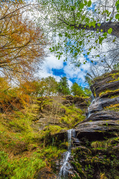 Uguna falls in the forest in Otzarreta mountains park in autumn