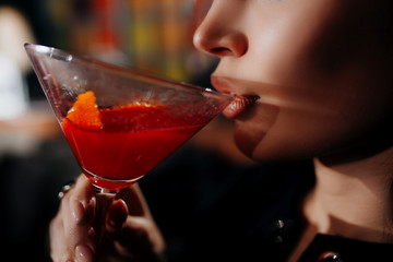 young girl drinking red lip cocktail close up