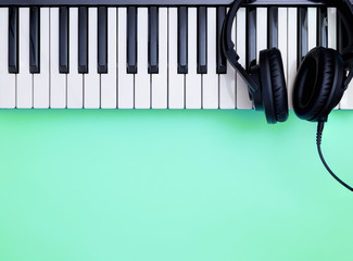Music Keyboard and Music headphone on teal © junce11