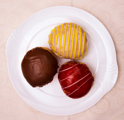 Three special jam doughnut filled with vanilla raspberry jelly, advocaat, chocolate on a china plate, Baden Wuerttemberg, Germany, Europe