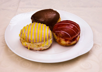 Three special jam doughnut filled with vanilla raspberry jelly, advocaat, chocolate on a china plate, Baden Wuerttemberg, Germany, Europe