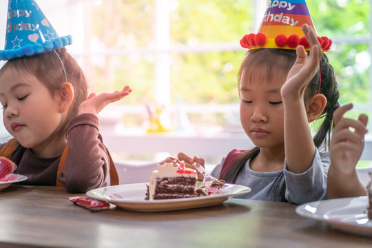 Asian Children Is Happy Eating Her Birthday Cake In Party