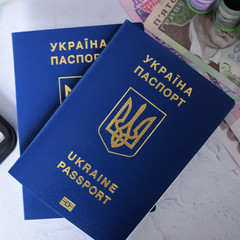 Two passports of ukraine on the background of money. The concept of travel and business