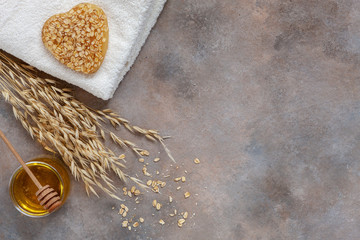 Homemade natural oatmeal soap, fresh honey and towel. Natural skin care. Spa kit for beauty and health. Close up, top view