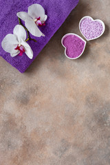 Orchid flower, aroma sea salt,  natural cosmetic clay, and towel. Natural skin care. Spa kit for beauty and health. Close up, top view
