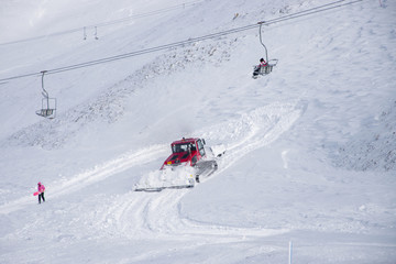 Snow groomer machine prepares the snow for recreational activities in a slope at Velouchi mountain in Karpenissi, Greece