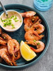 Shrimp glazed in soy sauce with green onion and lemon.